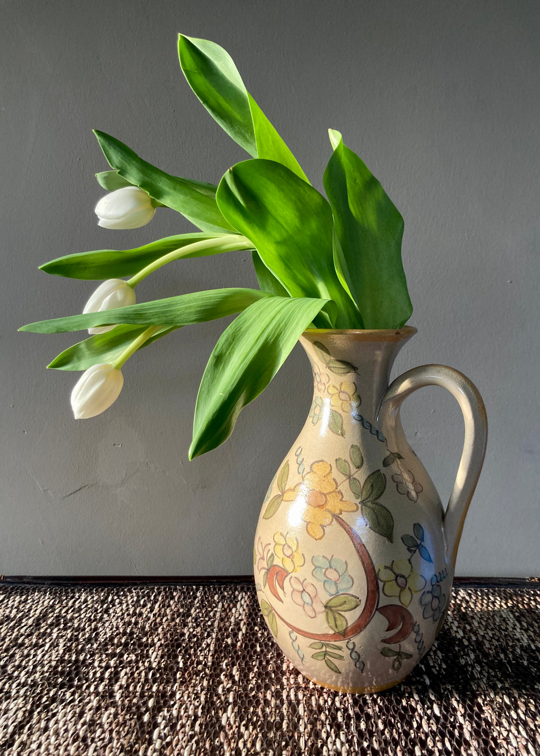 Naturalistic jug hand painted with floral design in muted shades