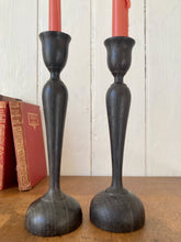 Load image into Gallery viewer, An elegant pair of black vintage hardwood Art Nouveau style candlesticks