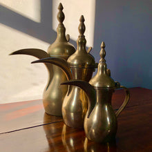 Load image into Gallery viewer, A striking set of three graduated size brass coffee pots