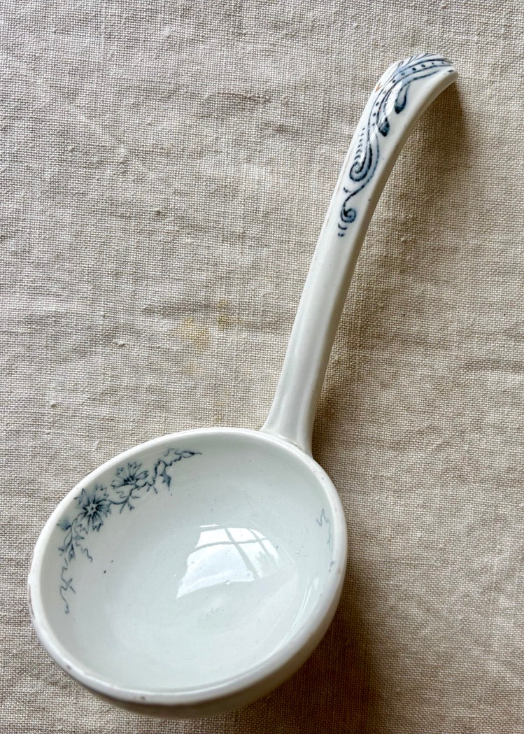 A china ladle with blue botanical detailing