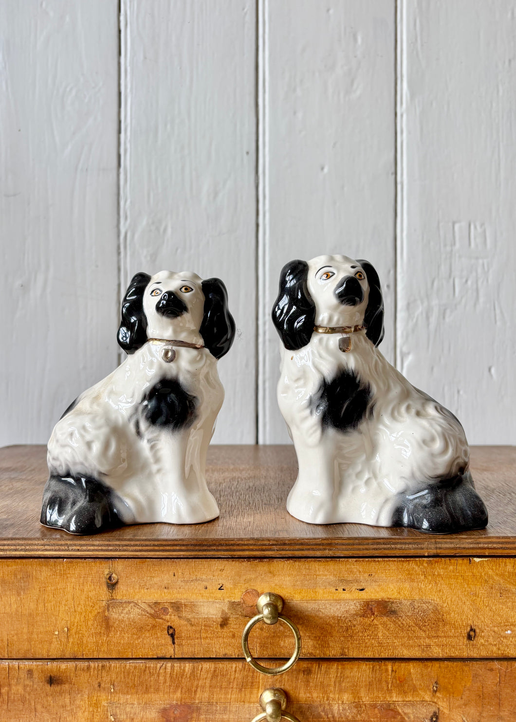 A pair of small black and white Beswick King Charles Spaniel mantle dogs