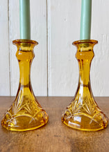 Load image into Gallery viewer, A pair of amber pressed glass candlesticks
