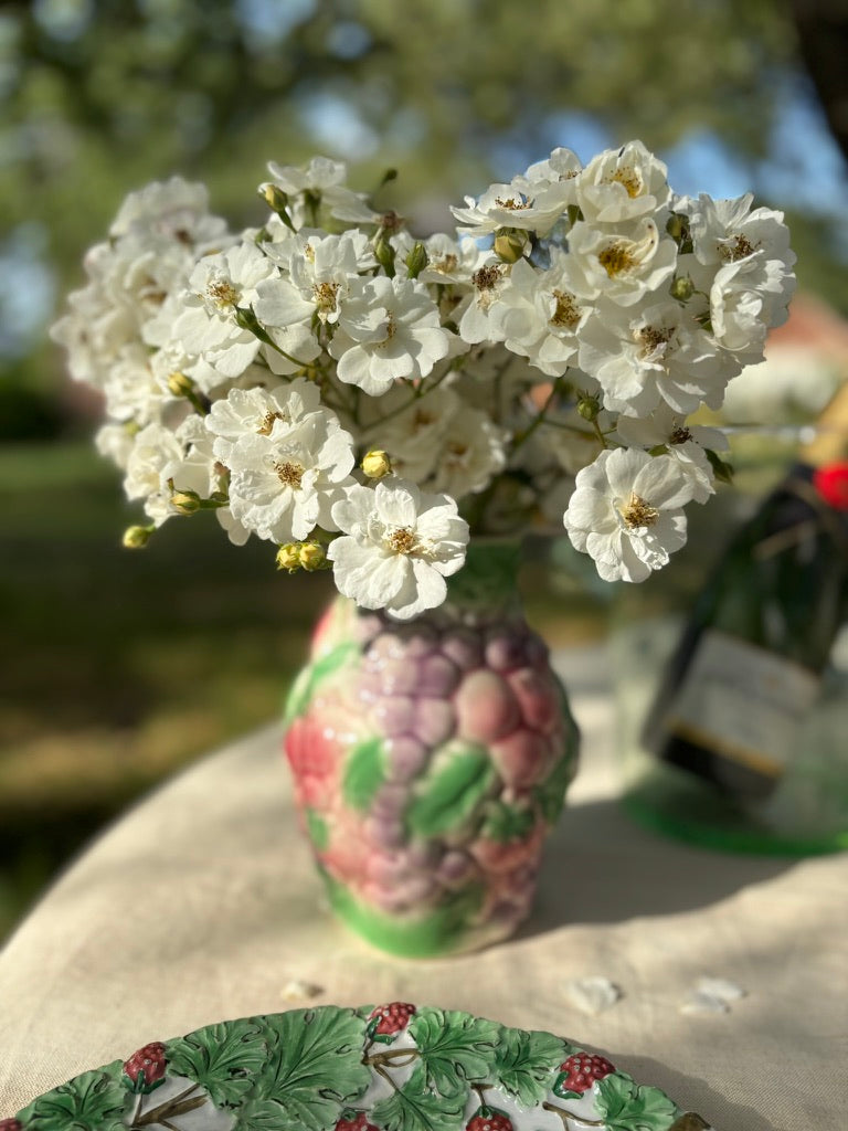 Fruity majolica jug with grapes and strawberries