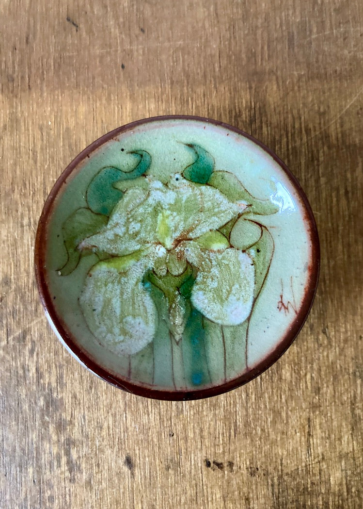 Small studio pottery footed dish with hand painted white Iris