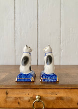 Load image into Gallery viewer, A pair of china cats on blue cushions
