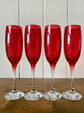 Load image into Gallery viewer, A set of 4 vintage cranberry glass champagne flutes
