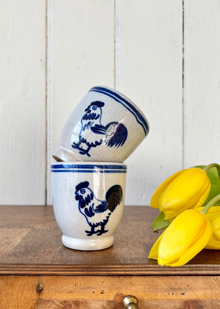 A pair of rustic French-style chicken mugs