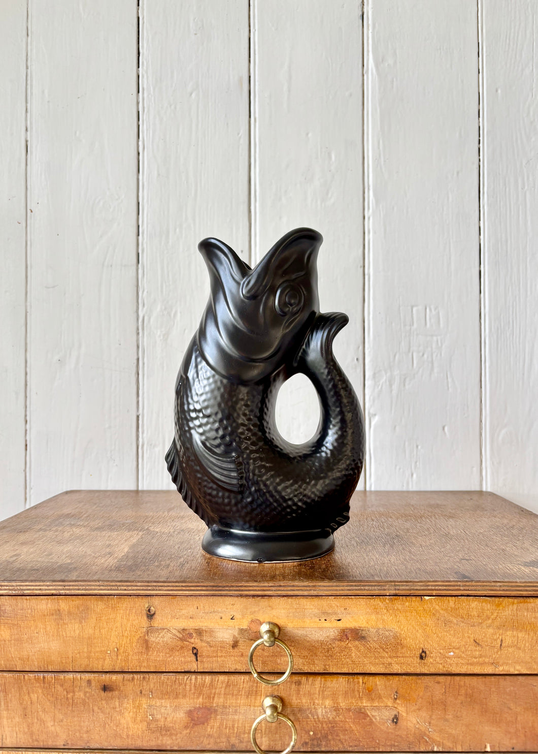 A black Dartmouth Pottery gluggle or gurgle jug