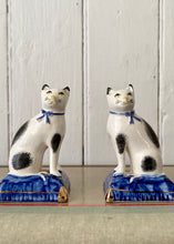 Load image into Gallery viewer, A pair of china cats on blue cushions
