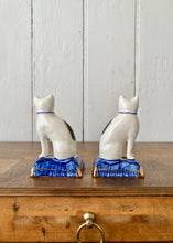 Load image into Gallery viewer, A pair of china cats on blue cushions
