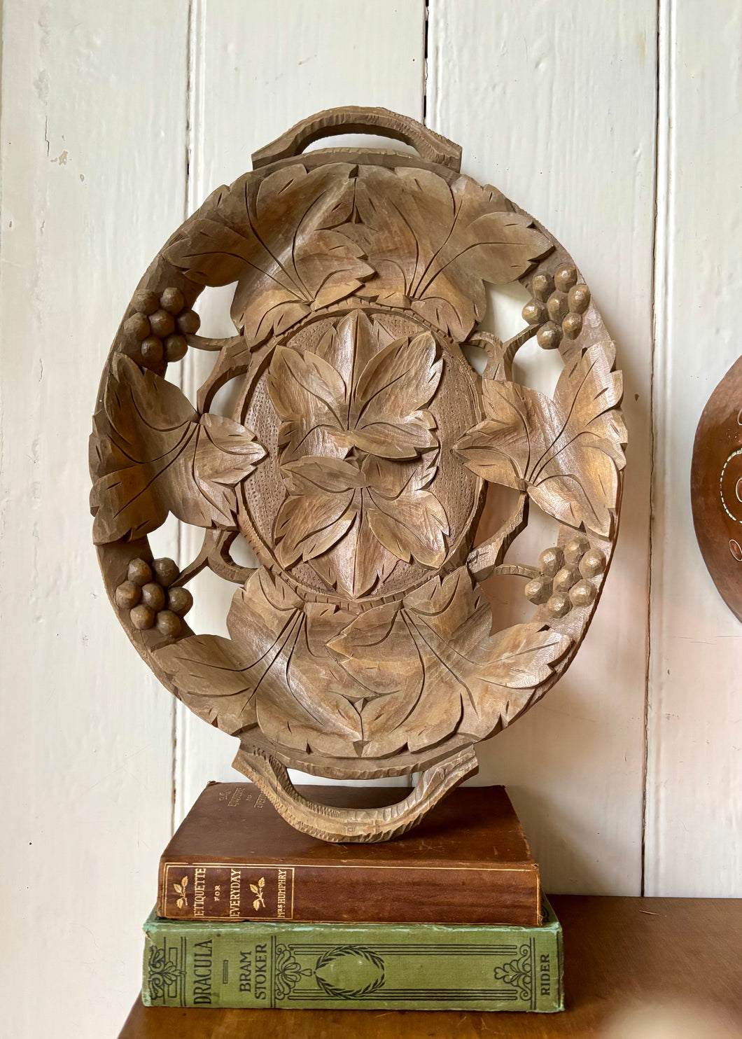 Hand carved wooden platter with grapes and vine leaves