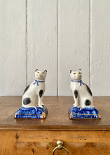 Load image into Gallery viewer, A pair of china cats on blue cushions
