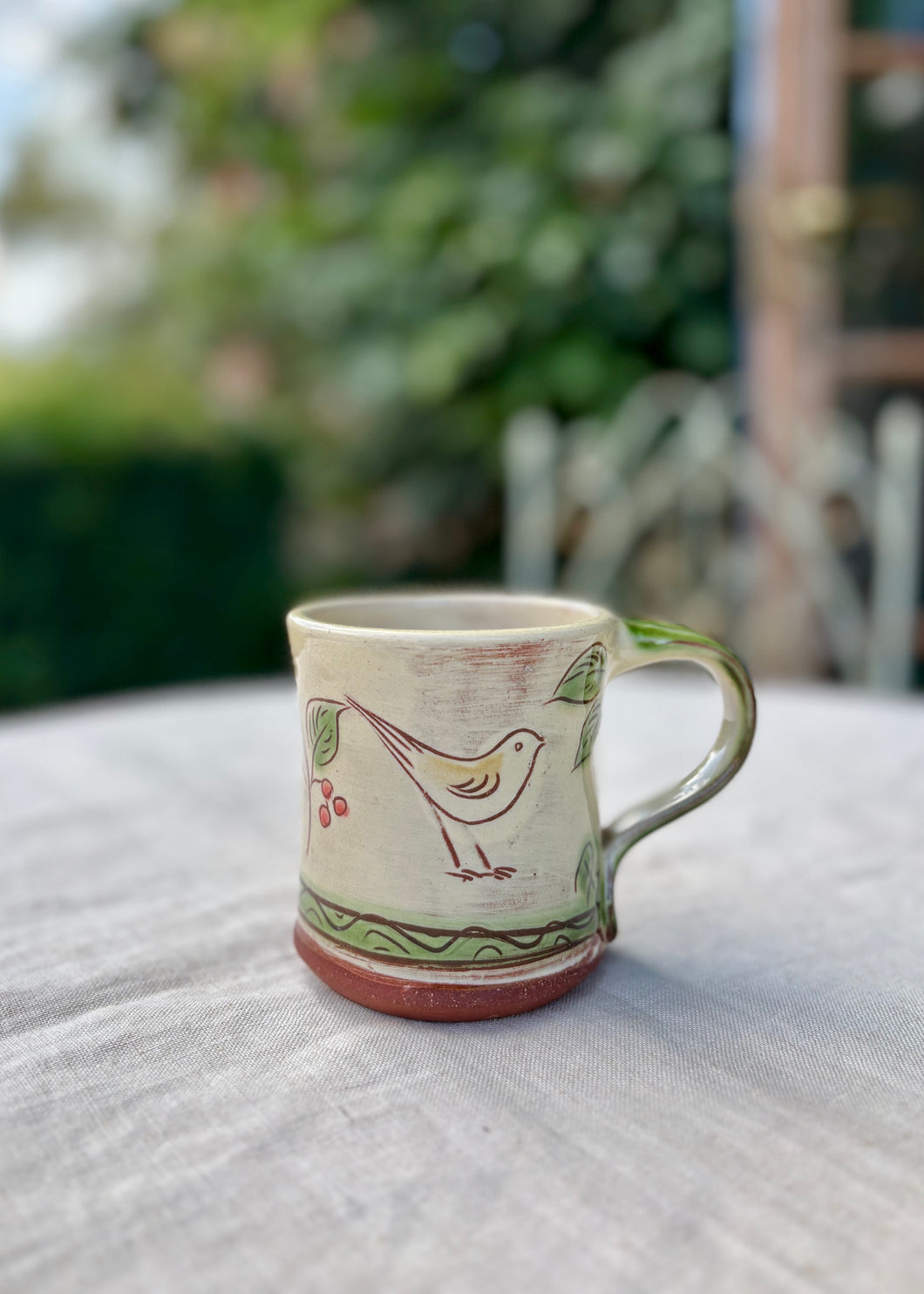 Small studio ware mug with birds and berries