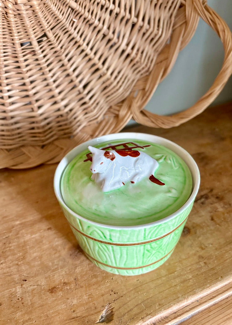 Green barrel-style butter dish with cow on lid