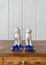Load image into Gallery viewer, A pair of china cats on blue cushions
