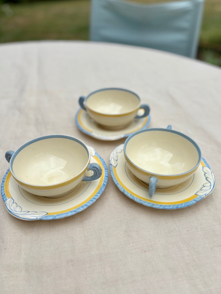 A set of 3 breakfast twin handled cups and saucers