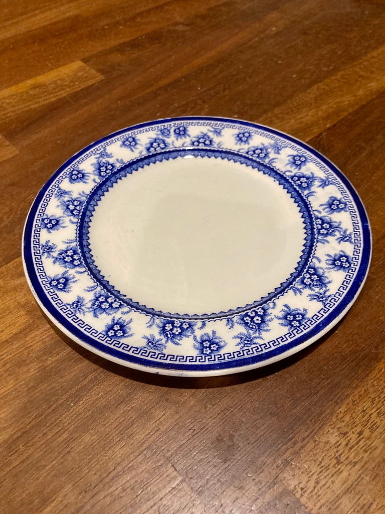 A pair of blue and white floral border side plates