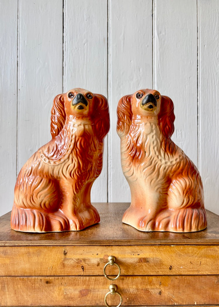 An antique pair of chestnut Staffordshire mantle dogs