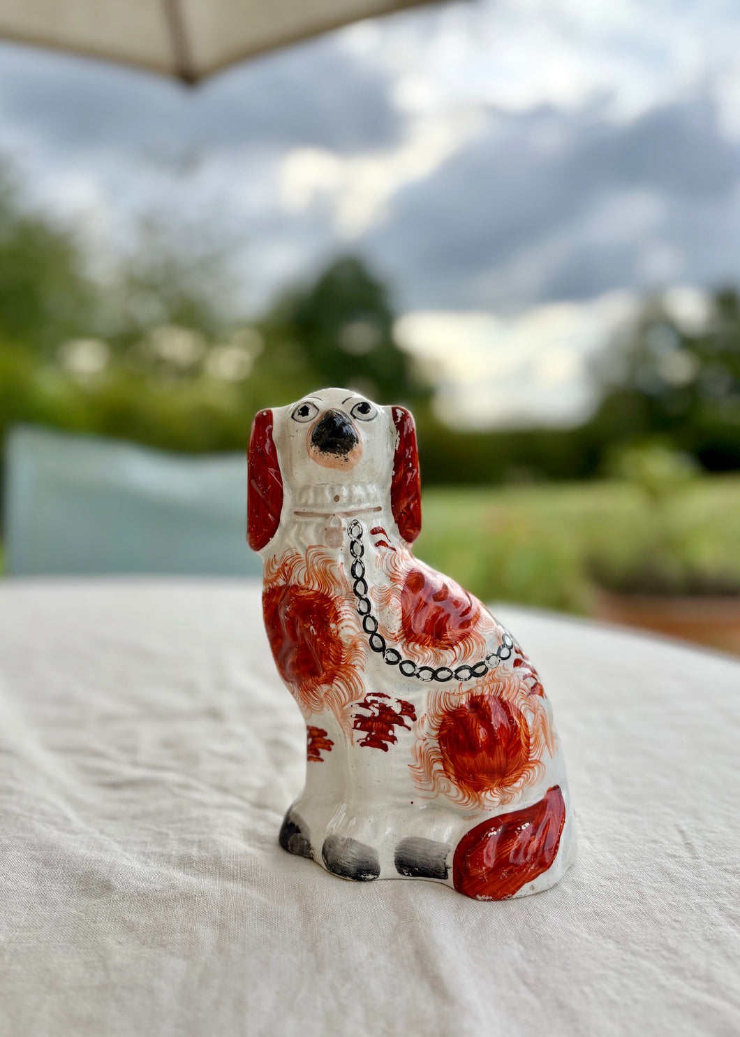 Single antique mantle dog with hand painted russet markings