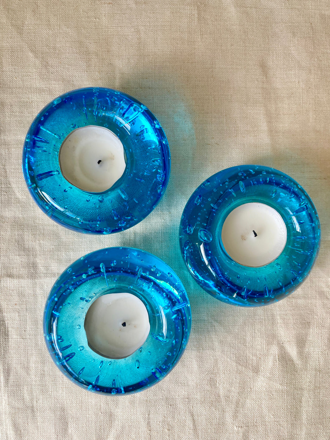 A set of 3 turquoise bubble glass tea light holders