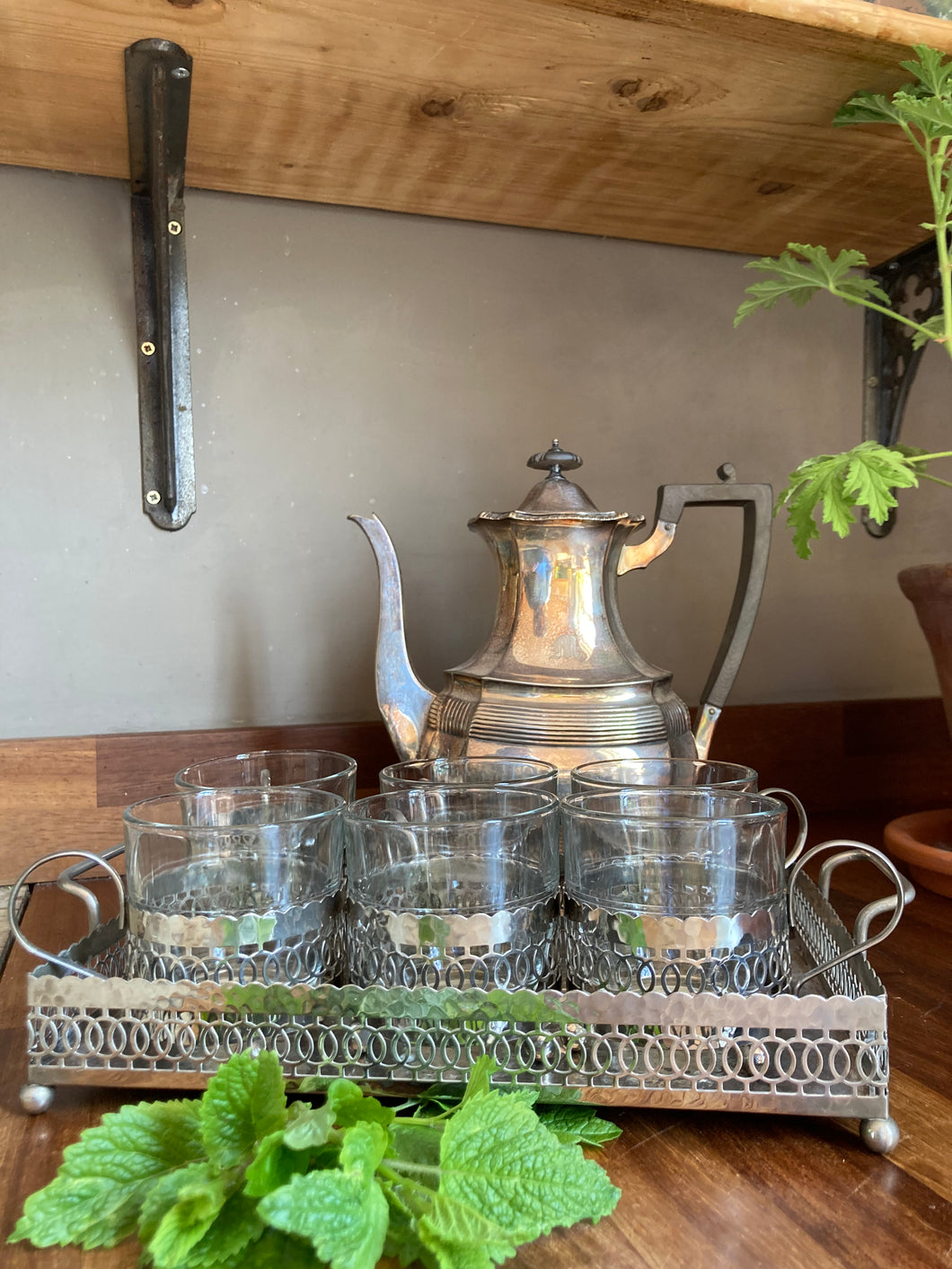 A set of Moroccan inspired white metal glass holders and matching serving tray