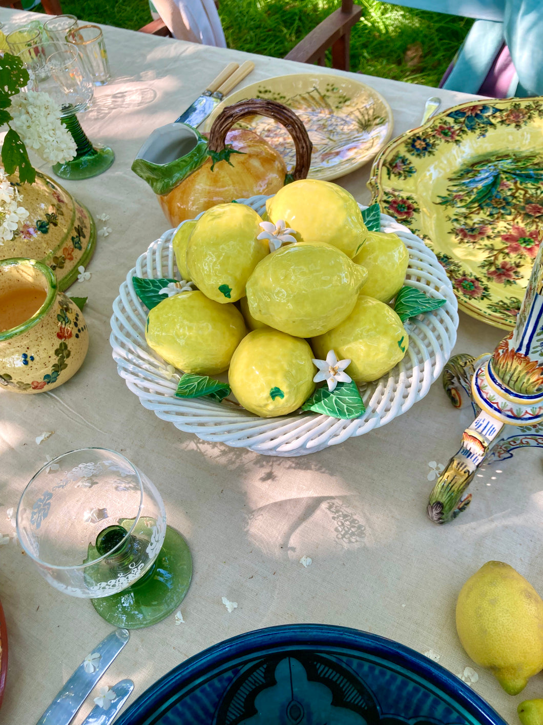 Pierced lattice basket-style pedestal dish full of majolica lemons