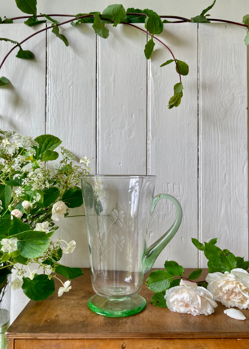 Tall pale green glass jug or pitcher etched with leaves