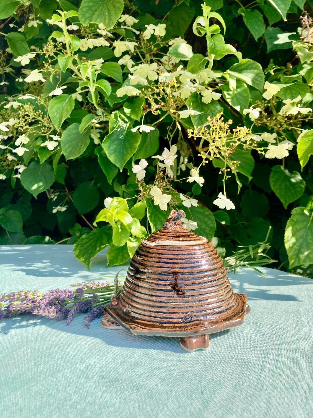 A studio pottery beehive style honey pot