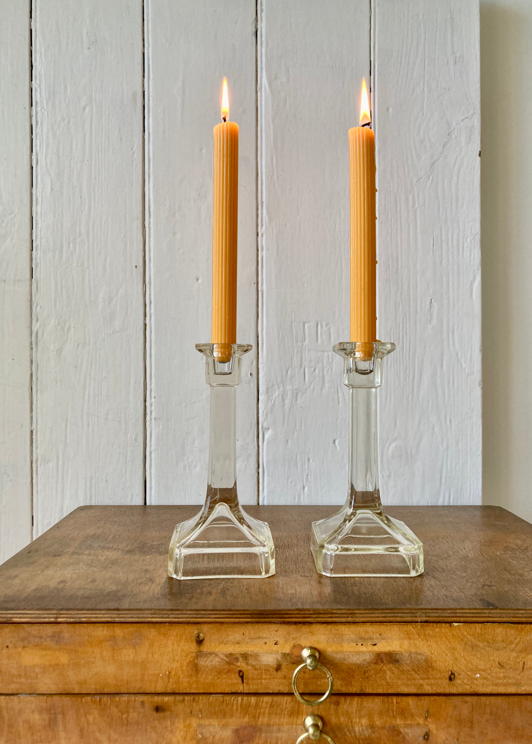 An elegant pair of clear pressed glass candlesticks