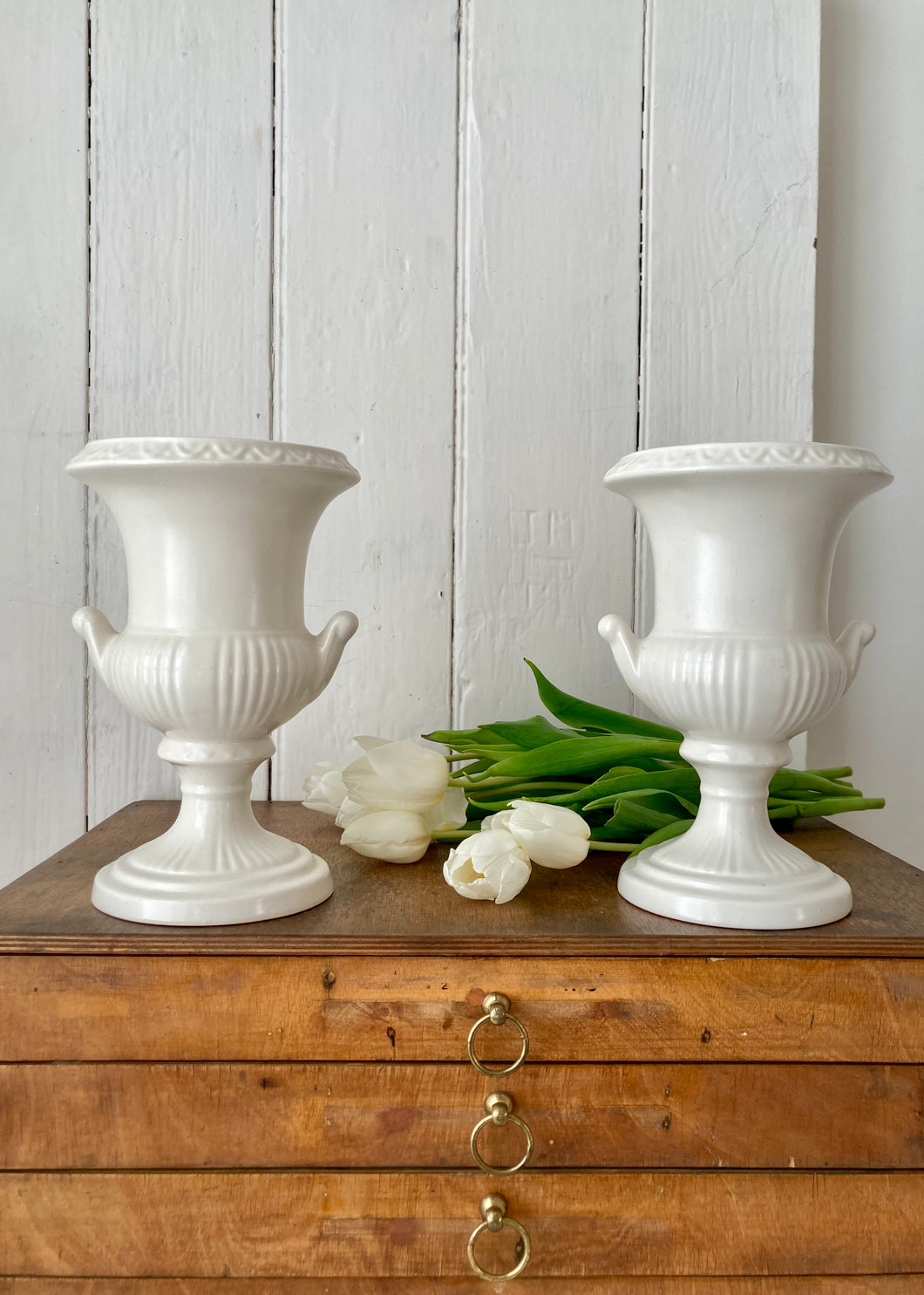 A pair of elegant Dartmouth Pottery classical white mantle urns