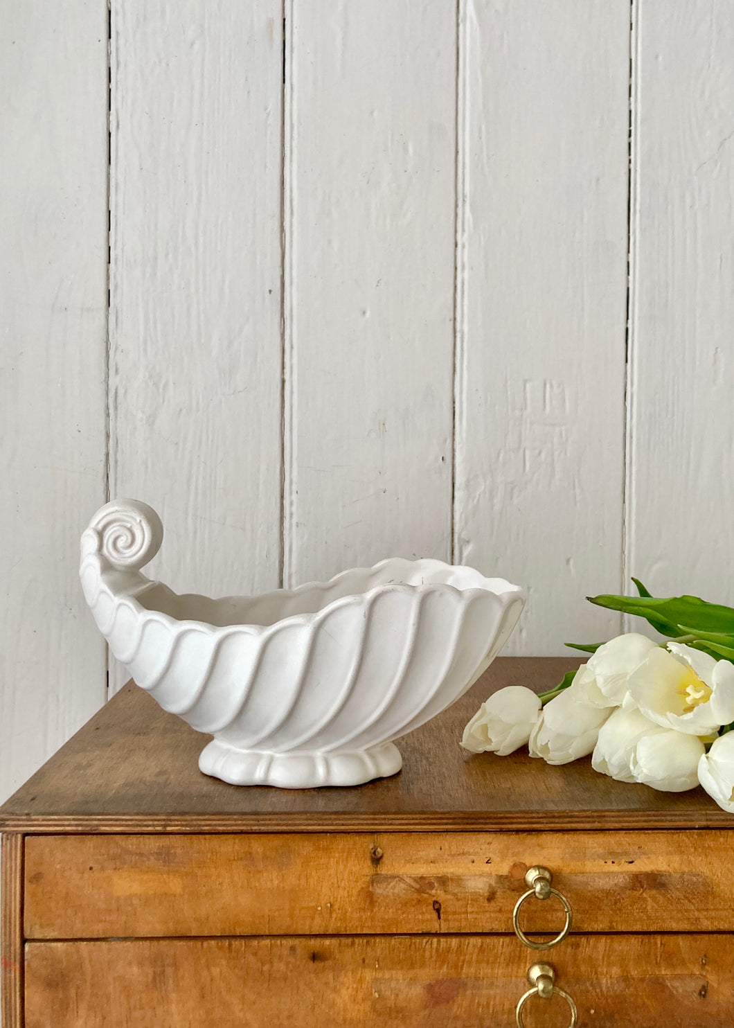 White scrolled shell mantle vase by Prices Bros.