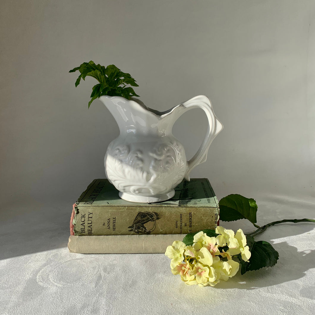 White china jug with stylised fern design