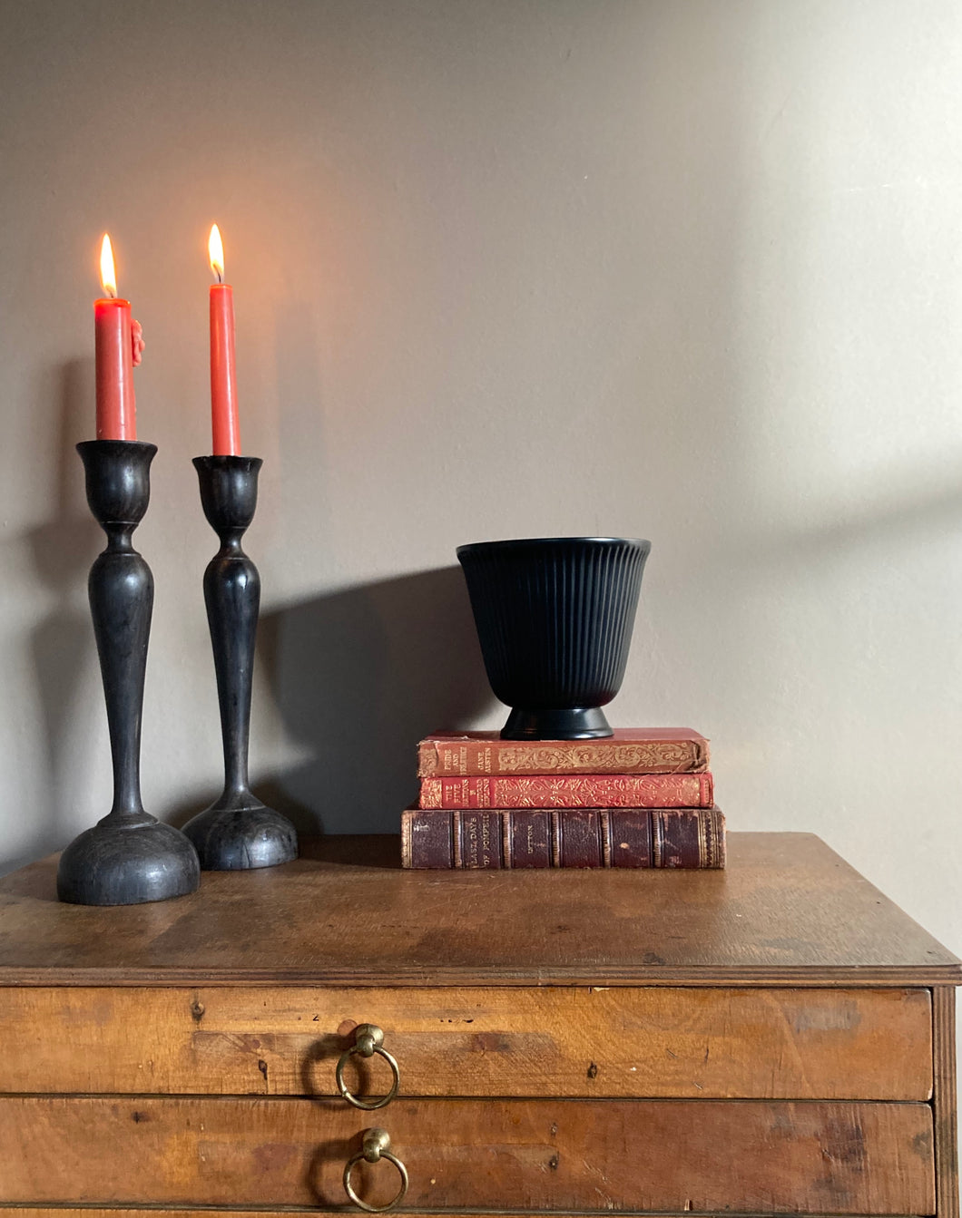 An elegant pair of black vintage hardwood Art Nouveau style candlesticks