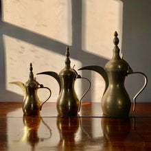 Load image into Gallery viewer, A striking set of three graduated size brass coffee pots
