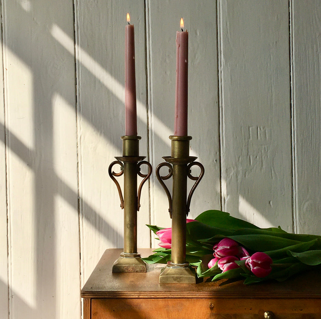 Pair of brass candlesticks with copper scrolls